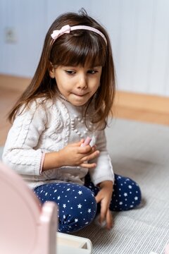 Child Holding Toy Lipstick