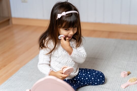 Toddler playing with makeup