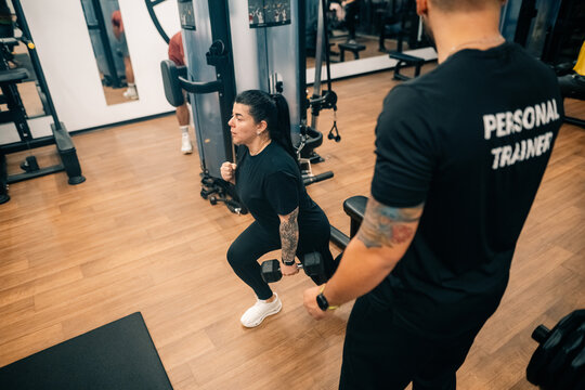 Training With Weights in Fitness Gym During Afternoon Session
