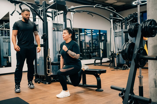 Training With Weights in Fitness Gym During Afternoon Session
