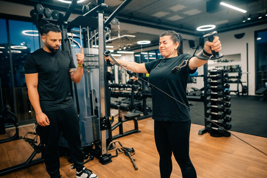 Fitness Training Session at Gym With Coach and Woman