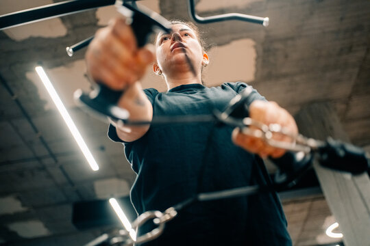 Woman Exercises With Gym Equipment in a Fitness Center