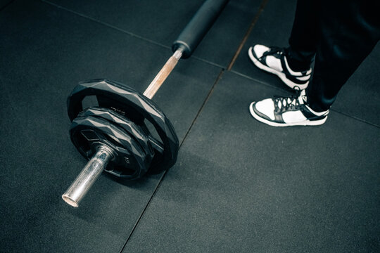 Barbell and Sneakers in a Gym Setting During Workout Session