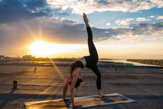 Sunset Yoga Balance Pose On Rooftop