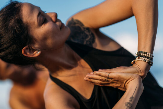 Female Yoga Pose Outdoors With Intertwined Hands