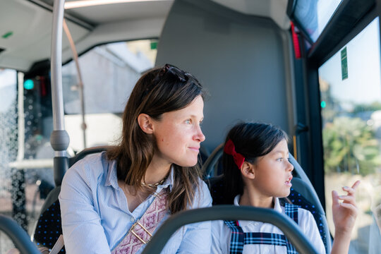 Mother and daughter commuting to school in bus 