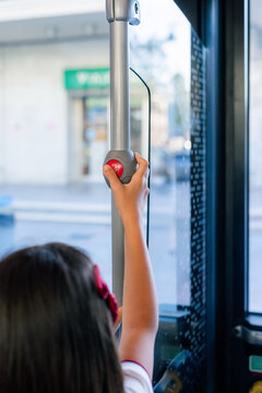 Child pressing stop button in bus 