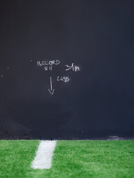 Record Markings on Black Wall in Sports Area