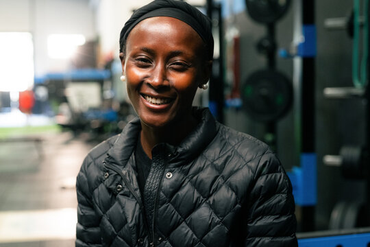 Smiling Woman in a Gym During a Workout Session