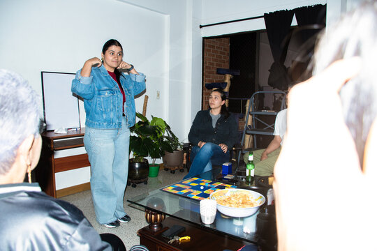 Family Enjoys Game Night While Sharing Snacks and Drinks