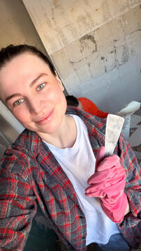 Smiling woman renovating a room  

