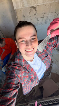 Smiling woman renovating a room  
