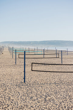 Beach Volleyball Courts Set up on Sandy Shore in Sunny Weather