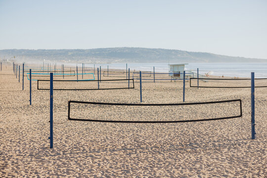 Beach volleyball courts lined up on sandy shoreline