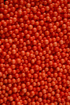 Red Round spheres Fill the Frame on a Flat Surface