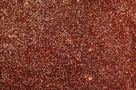 Sparkling Glitter in Warm Shades Fills the Surface During Bright Light