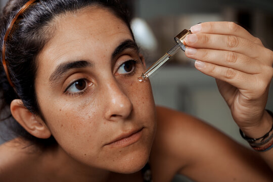 Woman Applying Face Serum