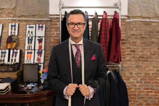 Confident male mature tailor in studio