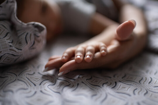 Unrecognizable black mother and child touching hands in morning