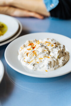 Yogurt eggplant dip on white plate