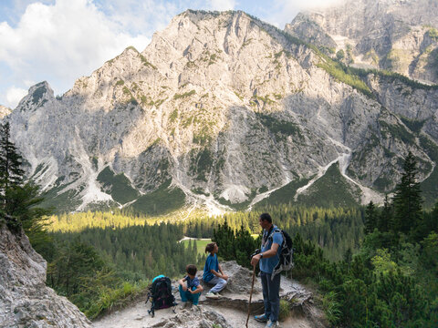 Family of hikers explores the Mountains in a National Park in Slovenia