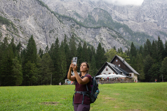Hiker Takes a Mobile Phone Picture in a Mountain Area in Slovenia