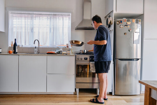 Middle aged man cooking in a kitchen