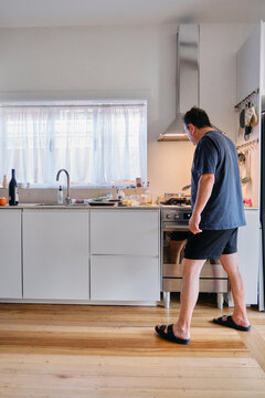 Middle aged man cooking in a kitchen