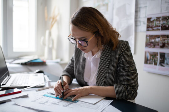 Female Interior designer making draft in office