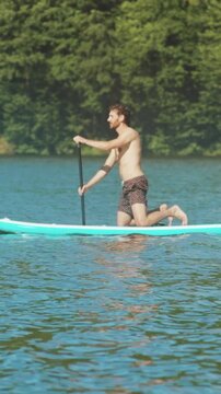 Man practicing paddling on tranquil lake, Individual developing paddle skills in peaceful lakeside setting