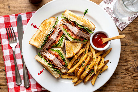 Classic Triple Decker Club Sandwich with French Fries Overhead View