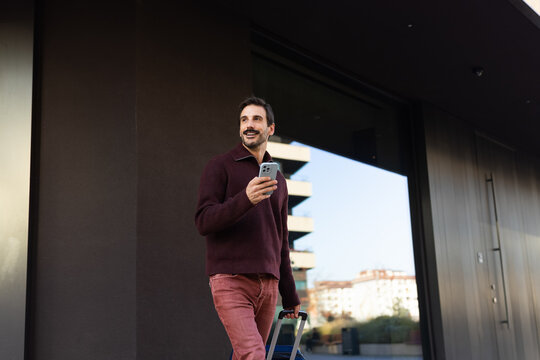 Man with luggage and mobile