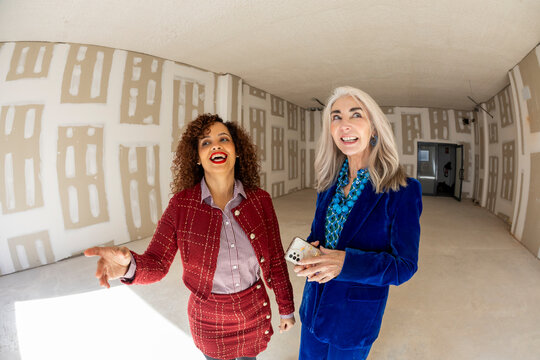 Realtor agent showing empty commercial space to potential client