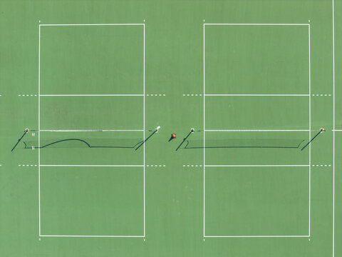 Aerial view of two green volleyball courts with white boundary lines Taiwan.