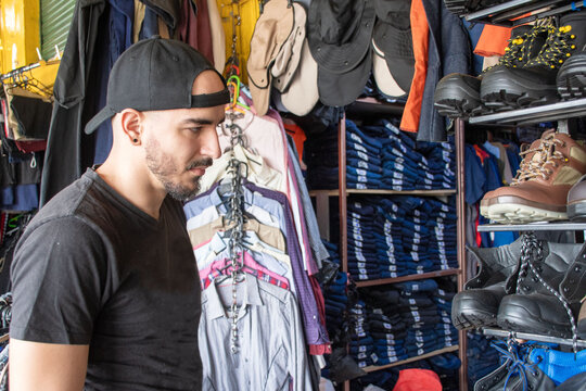 Man Shops for Shoes in a Local Thrift Store 