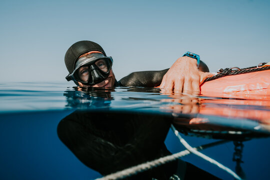 freediver resting calmly at water surface