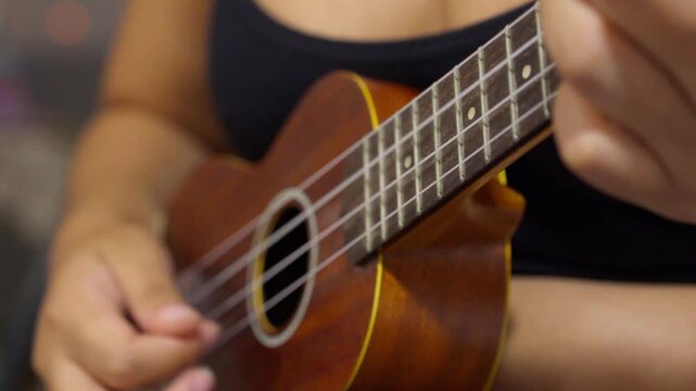 Close up of a musician playing ukulele
