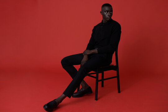 Black man in suit posing in studio