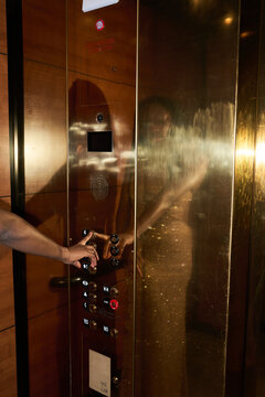 Person Pressing Elevator Buttons