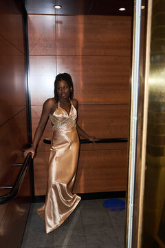 Young Woman Stands in Elevator