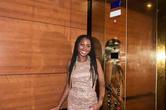 Girl in Elevator wearing an evening dress