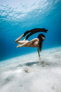 Woman moving peacefully in crystal clear Mediterranean water