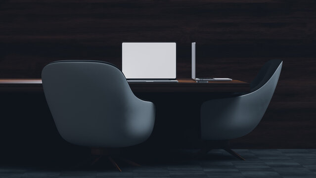 Modern desk setup with laptop and chairs in quiet room