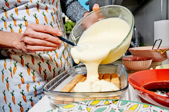 adding a creamy tiramisu layer to the ladyfinger base