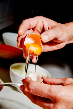 egg white flowing into a bowl during kitchen preparation
