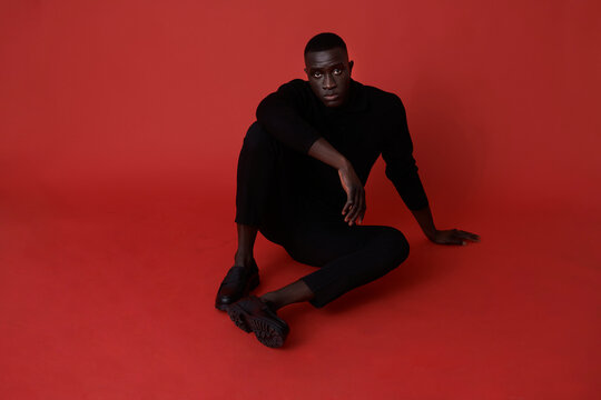 Black man in elegant clothes posing in studio