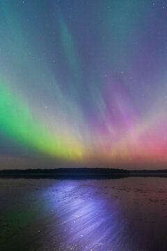 Flashlight Beam on the Water, Aurora Borealis in the Sky