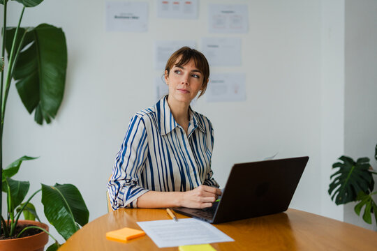 Elegant woman works on her laptop