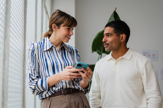 Colleagues discuss work-related topics indoors