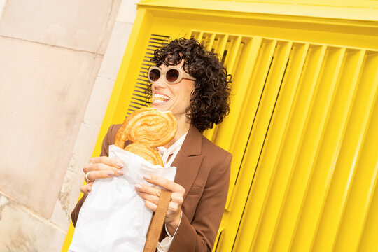 Woman eating pastry outdoors